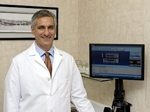  Dr Rossetti stands in front of digital x-rays which is one of many dental services offered in Richmond, VA.