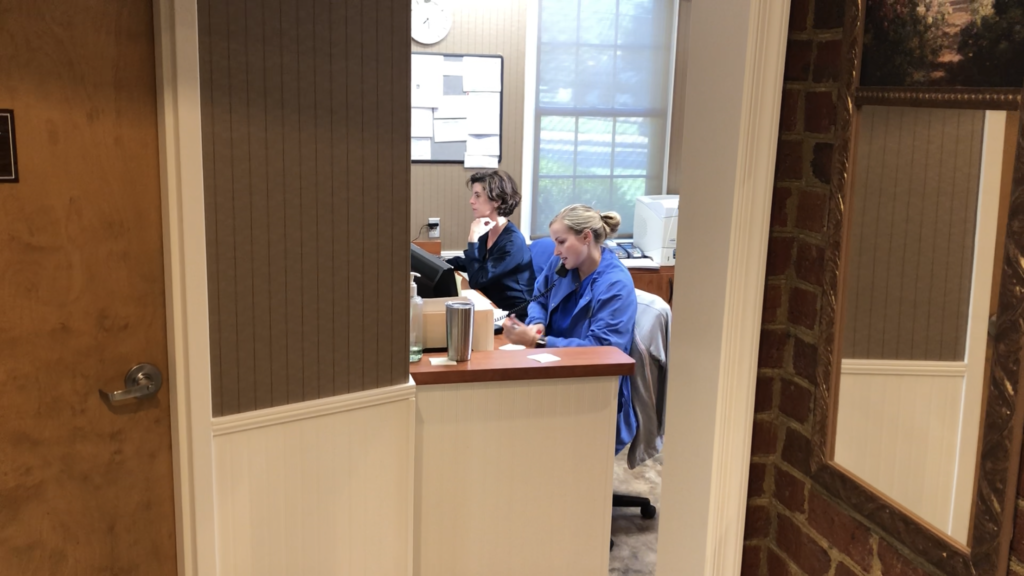 receptionists scheduling appointments at the office of Drs. Rossetti, Myers, & Kondorossy