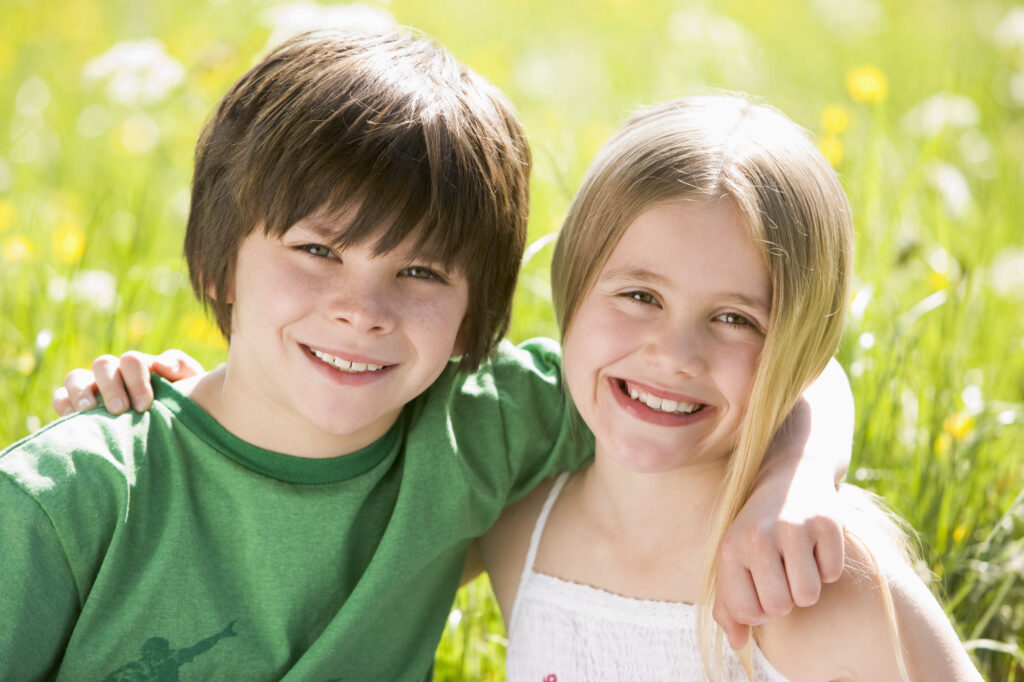 Brother and sister smiling with healthy teeth from the kids dentistry services in Richmond, VA.