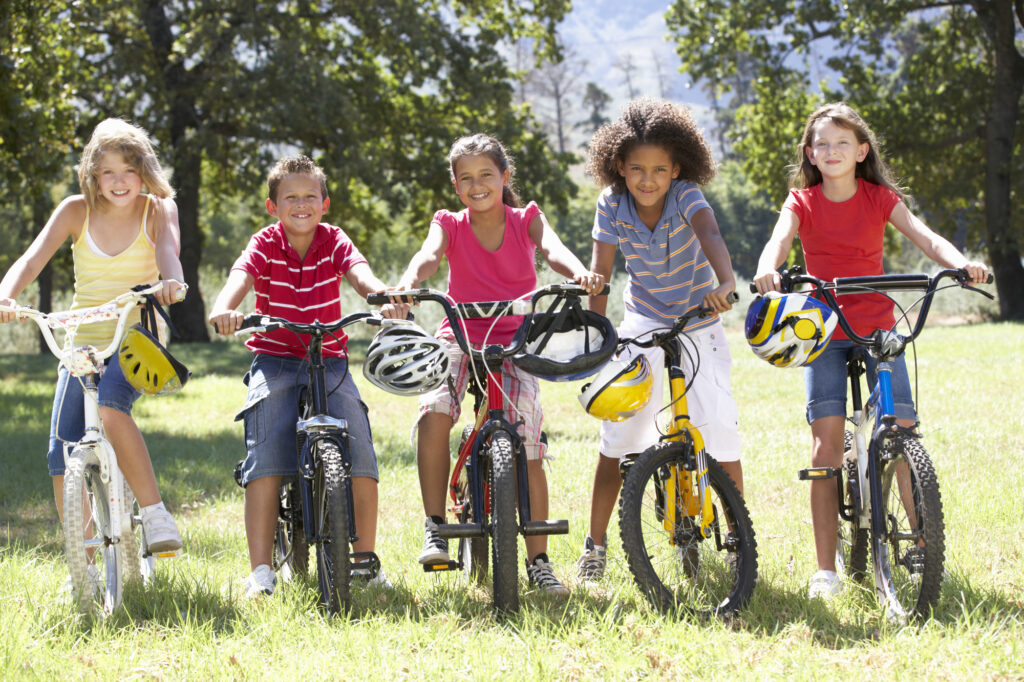 girl riding bikes with her friends after visiting the dentist