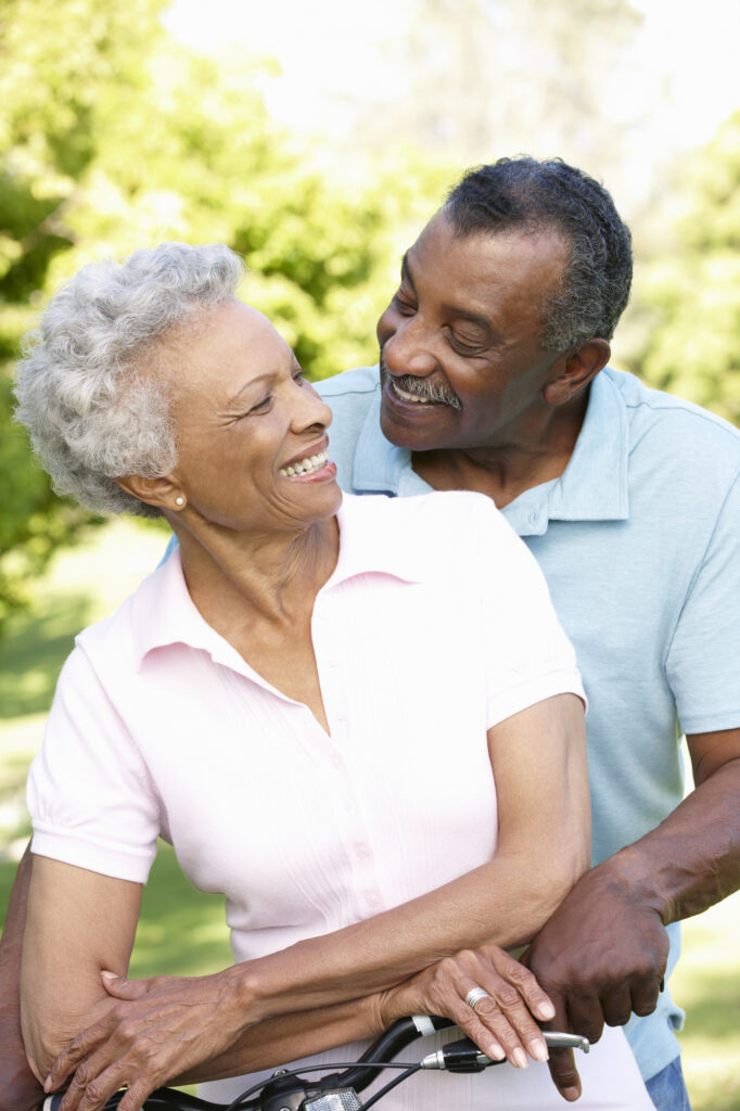 Senior African American Couple smiling with perfect fitting dentures which is a part of the restorative dentistry services in Richmond, VA.